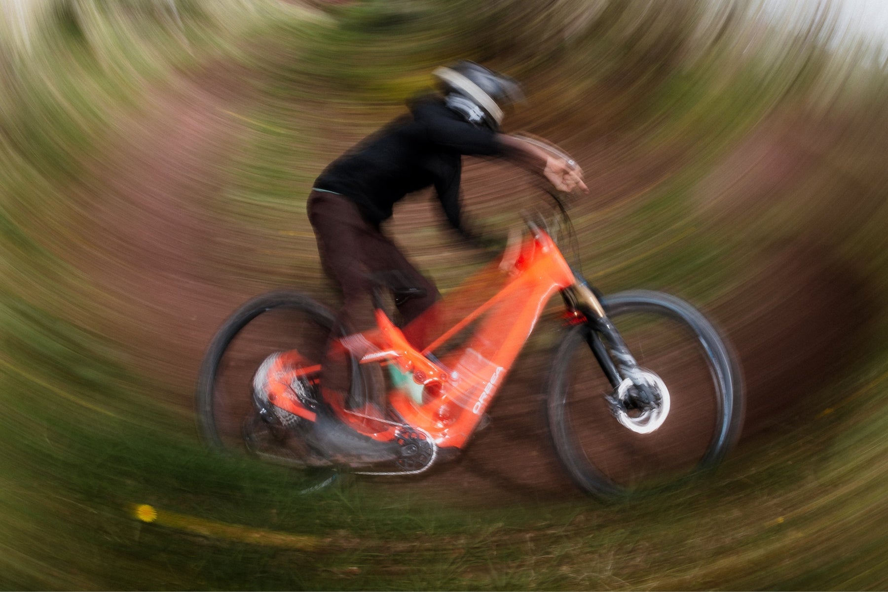 mtb rider on orbea wild lt, blurry background professional lifestyle image