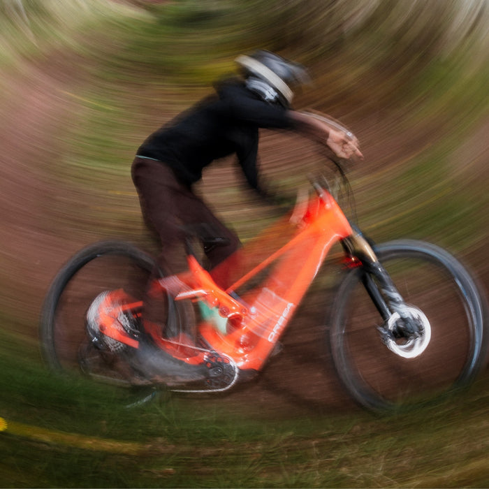 mtb rider on orbea wild lt, blurry background professional lifestyle image