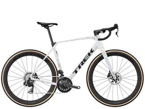 A Trek endurance road bicycle with a white frame featuring a subtle light blue and gray speckled pattern, black handlebars, black wheels, and tan sidewall tires, shown against a plain white background.