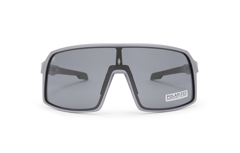 Carbon Black Charcoal sunglasses, front view with grey frames, grey stems with darker grey ends and shaded lenses on a white background