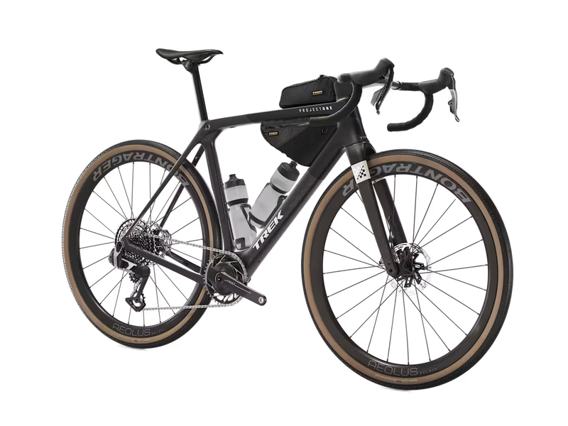 Two Trek Adventure Triangle Bags mounted behind the head tube on a road bike during a ride.