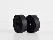Two rolls of Perfline XL handlebar tape in black, showing the extra‑tacky perforated texture.