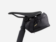 Black bicycle saddle bag attached to a bike seat on a white background