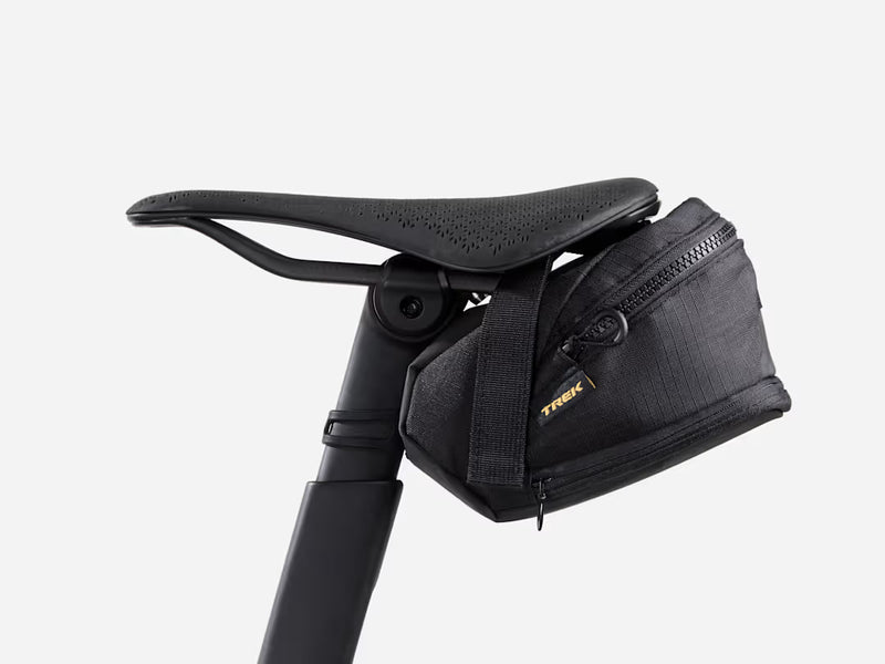 Black bicycle saddle bag attached to a bike seat on a white background