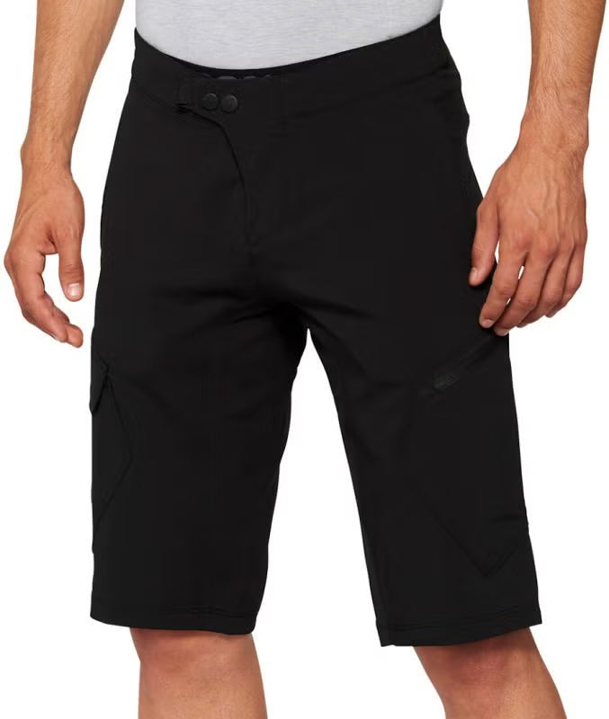 Front product view of black 100% Ridecamp mountain bike shorts featuring snap waist closure, fly detail, precision stitching, and subtle brand logo accents