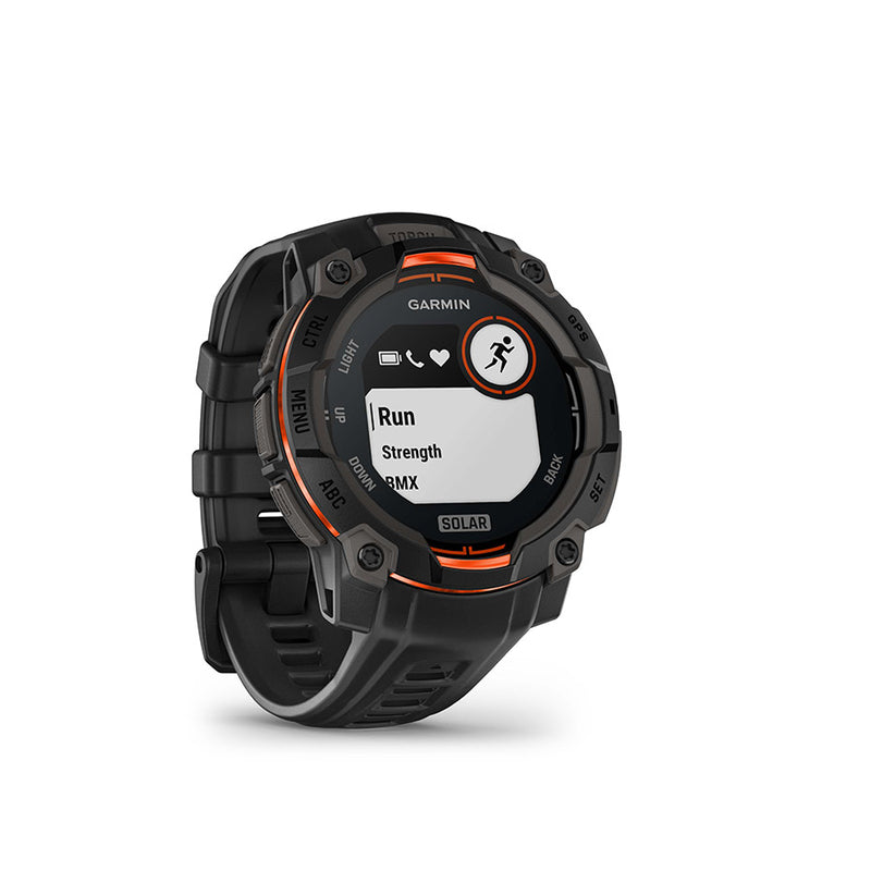 A Garmin Solar watch with a rugged black case and strap, featuring orange accents around the bezel and screen border, shown on a clean white background.