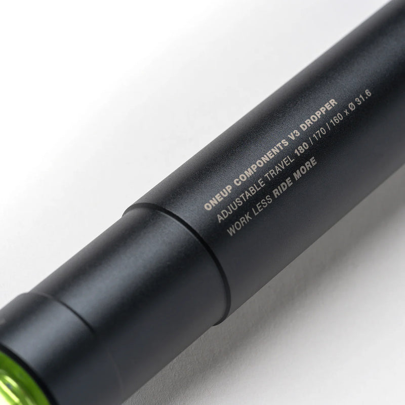 Close-up of a black bike component with text on a white background
