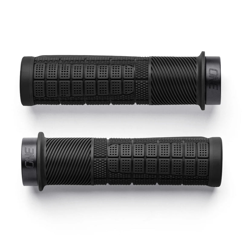 Pair of black motorcycle grips with textured pattern on a white background