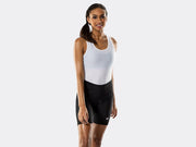 Bontrager Meraj Women's Cycling Short in black shown from the front on a female model, featuring a wide waistband, ergonomic stitching, moisture-wicking performance fit and white Bontrager logo above the left leg cuff.