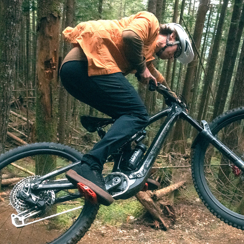 Person riding a mountain bike through a forest