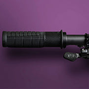 Black motorcycle handlebar grip on a purple background
