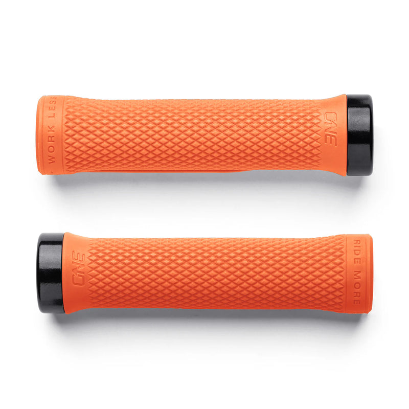 Two orange bicycle grips with black ends on a white background