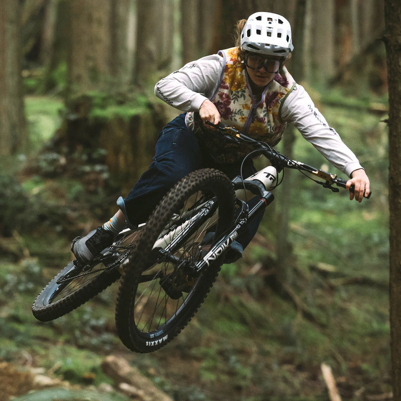 Person riding a mountain bike through a forest