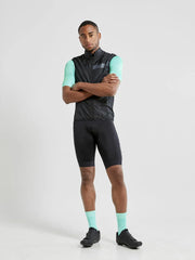 Craft Essence Light wind vest in black worn with arms crossed, front view showing the fit