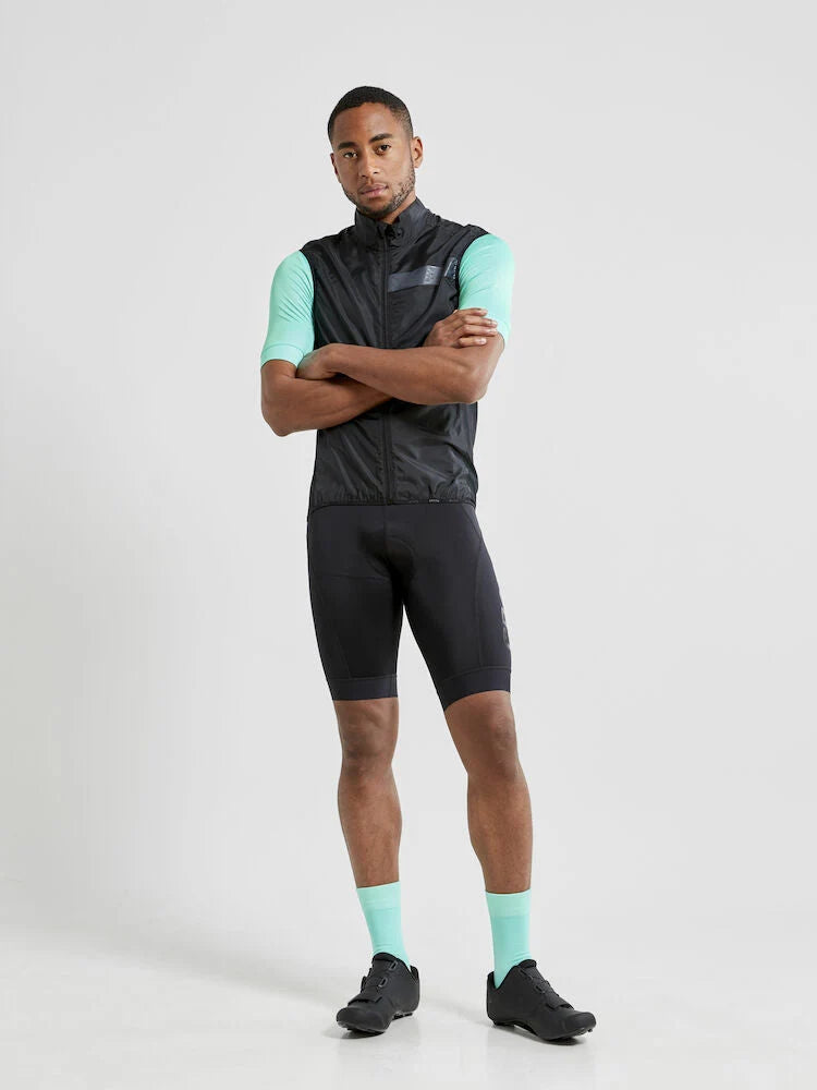 Craft Essence Light wind vest in black worn with arms crossed, front view showing the fit