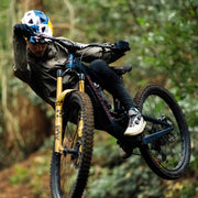 Person riding a mountain bike through a forest