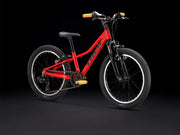 Red children's bicycle on a black background