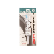 SILCA Ultimate Sealant Injector in its retail packaging, featuring a white syringe applicator with a blue plunger, mounted on a printed backing card with a teal header and black text.