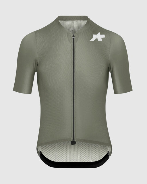 Green cycling jersey with a brand logo on a light gray background