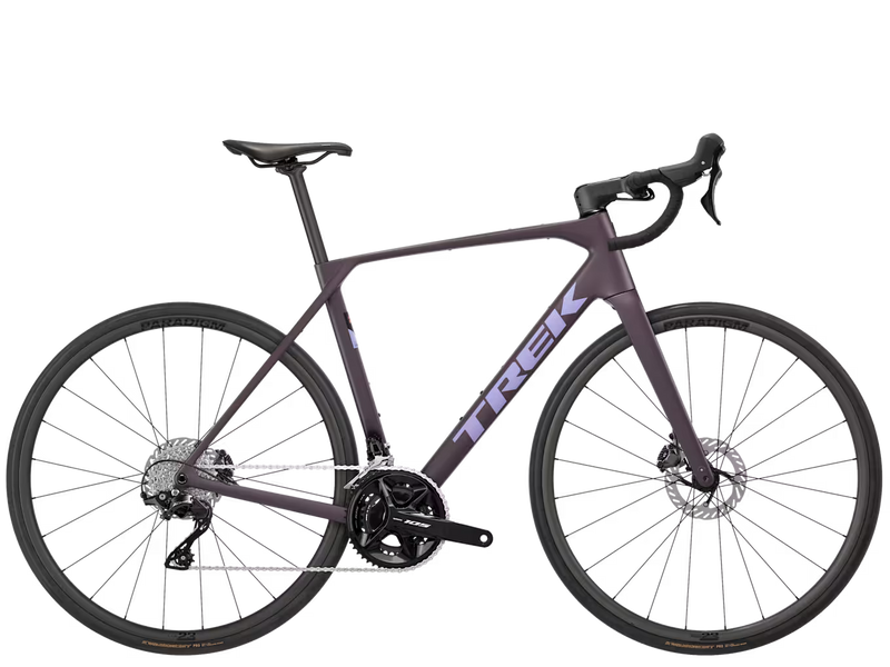 A matte dark purple Trek road bicycle with black components, drop handlebars, and disc brakes, shown from a side profile on a solid white background.
