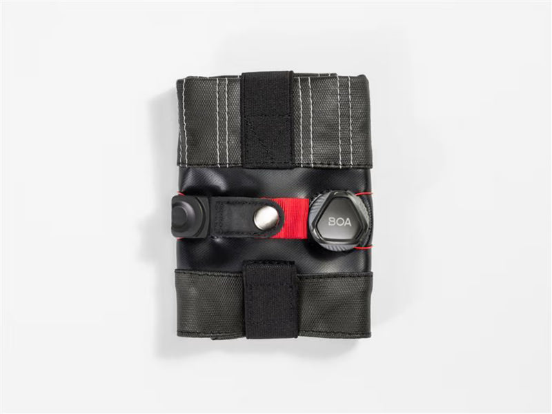 Rolled‑up Spring Roll seat bag showing its compact shape and BOA‑secured wrap.