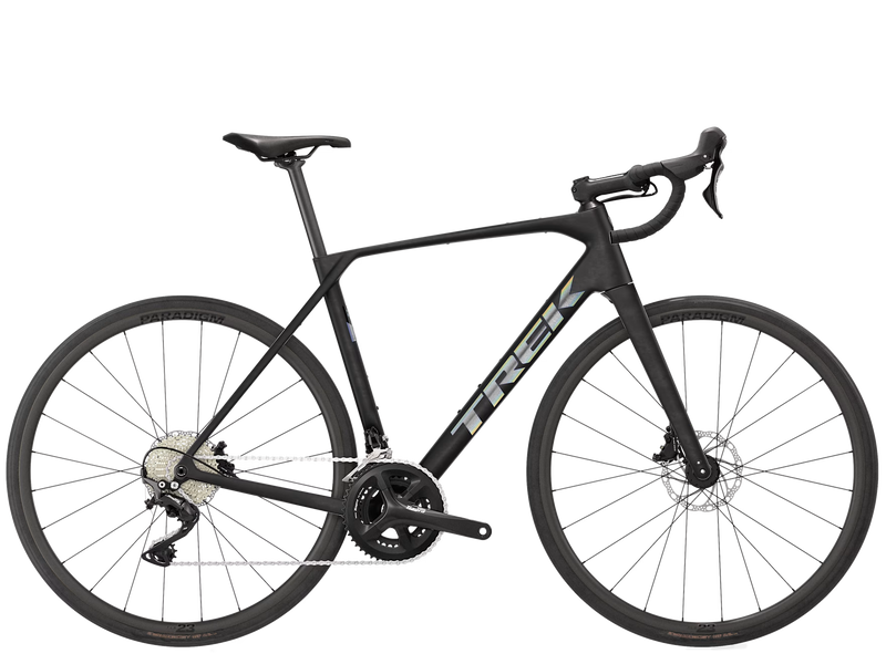 Trek Domane SL 4 Gen 5 road bike in Matte Deep Smoke, full side view showing Trek frame, handlebars, saddle, drivetrain, and wheels