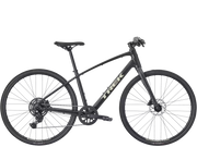 A black Trek hybrid fitness bicycle with a matte finish, featuring a step-through frame, rear suspension, and disc brakes, shown against a plain white background.