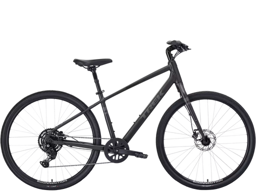 A matte black stepover cruiser Trek bicycle with a step-through frame, front suspension fork, disc brakes, and rear derailleur, shown from a side profile on a white background.