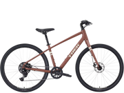 A Trek cruiser stepover bicycle with a matte brown/light red frame, black saddle and wheels, and white Trek branding on the down tube, shown against a plain white background.