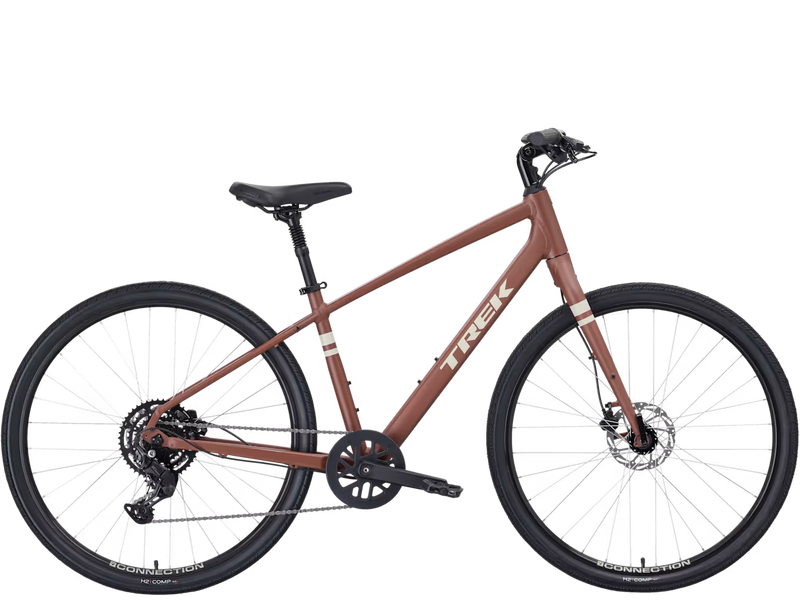 A Trek cruiser stepover bicycle with a matte brown/light red frame, black saddle and wheels, and white Trek branding on the down tube, shown against a plain white background.