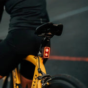 Lifestyle image of the Magicshine Seemee 300 taillight mounted to the back of a bicycle seatpost