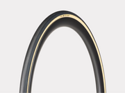 Close-up of a bicycle tire with a white rim on a light gray background