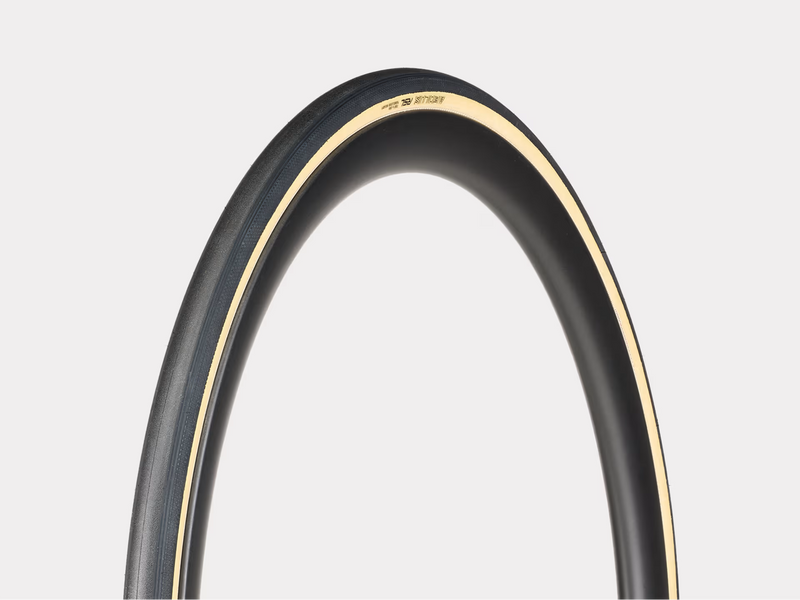 Close-up of a bicycle tire with a white rim on a light gray background