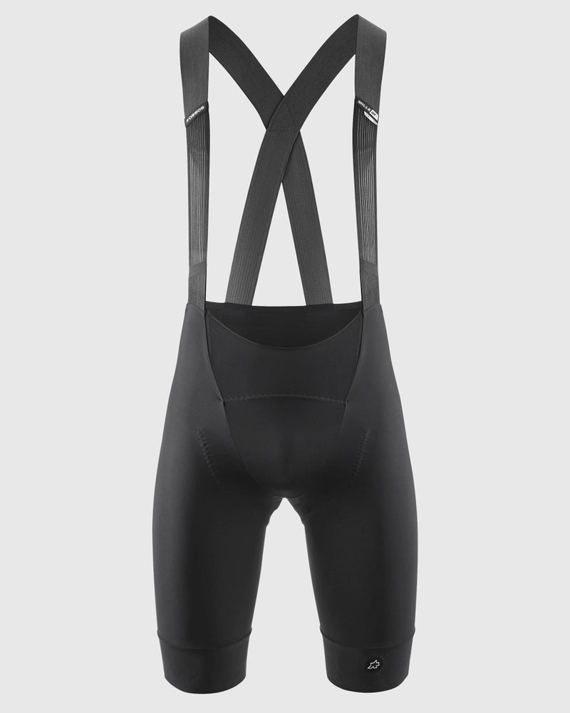 Black cycling bib shorts with straps on a light gray background
