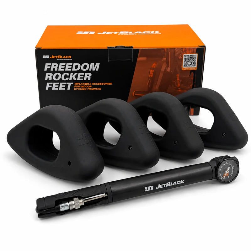 Product shot of four oval JetBlack Freedom Rocker Feet with the pump in front and the orange JetBlack packaging box behind them on a white background.