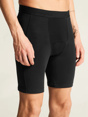 Close-up of black Craft Everyday Bike Liner Shorts on a model, front three-quarter view showing the side and inseam stitching
