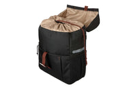 Gazelle bicycle pannier in black, three-quarter product view showing the brown interior, mounting strap, and drawstring closure