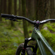 Green mountain bike in a forest setting