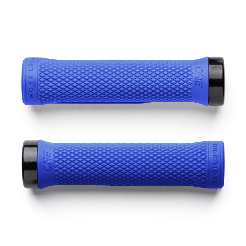 Two blue bicycle grips with textured surface on a white background