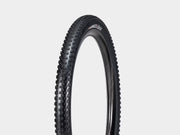 Bicycle tire with tread pattern on a light gray background