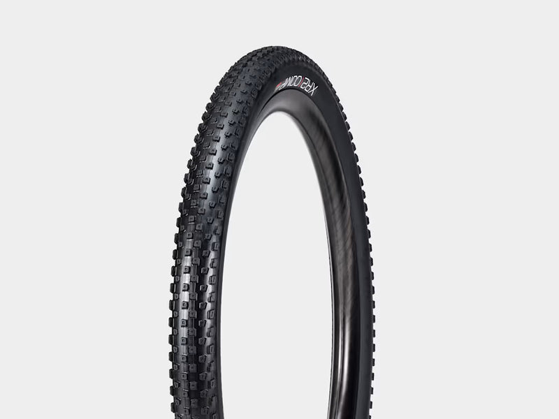 Bicycle tire with tread pattern on a light gray background