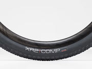 Close-up of a bicycle tire with 'XR2 COMP' branding on a white background