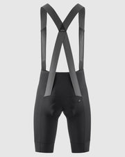 Black cycling bib shorts with suspenders on a light gray background