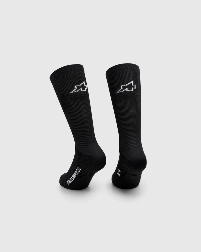 Two black socks with a logo on a light gray background