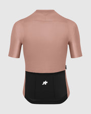 Pink cycling jersey with black bib shorts on a light gray background