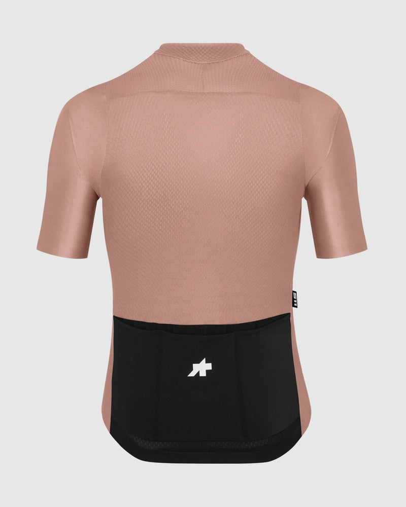 Pink cycling jersey with black bib shorts on a light gray background