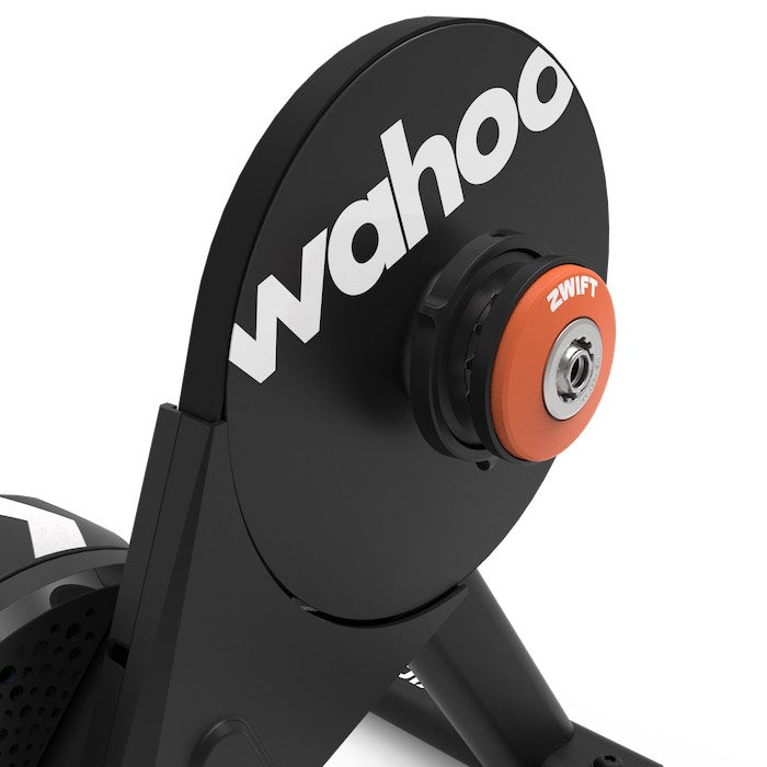 Close-up of the Wahoo KICKR CORE 2 with Zwift Cog and Click smart trainer, showing the Wahoo branding and orange Zwift Cog mounting interface
