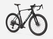 A black Trek endurance road bicycle with drop handlebars, disc brakes, and deep-section wheels, photographed on a clean light gray studio background.