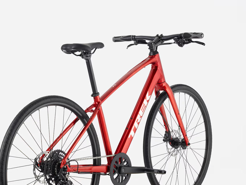 Red hybrid fitness bicycle on a white background