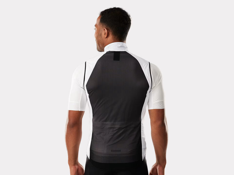 Man wearing a black and white cycling jersey on a plain background